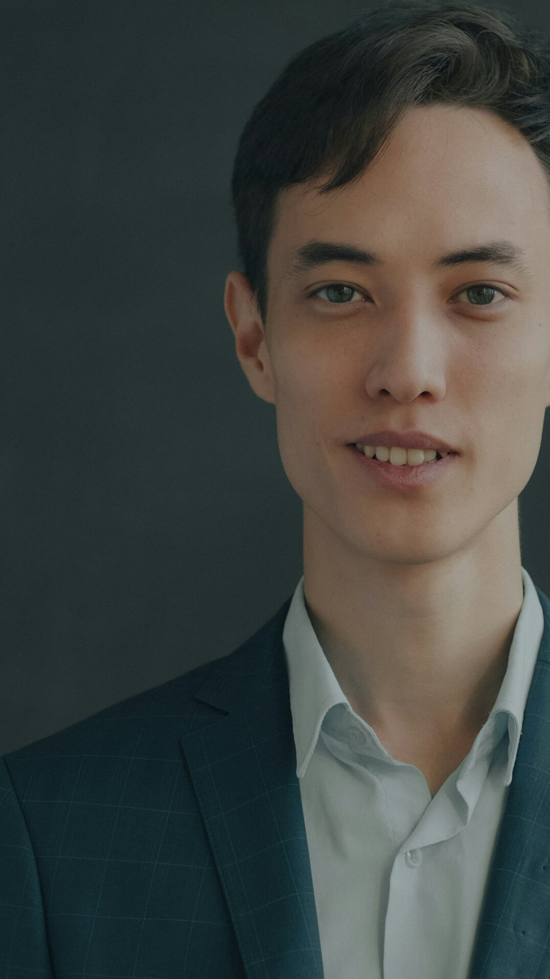 Smiling businessman in a suit looking at the camera